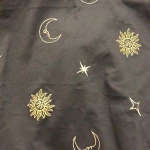 A navy blue tee shirt with moons and suns on it !!